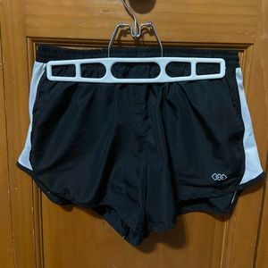 Used black athletic shorts with built in lining.